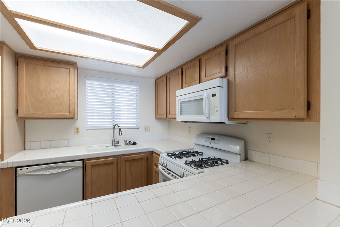 7100 West Pirates Cove Road, Unit 2089 Las Vegas, NV 89145 - Photo 10 of 32 TILE COUNTER TOPS, MICROWAVE LIGHT AND BRIGHT