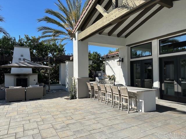 2527 Wellspring Street Carlsbad, CA 92010 - Photo 27 of 28 a view of a patio with table and chairs and potted plants