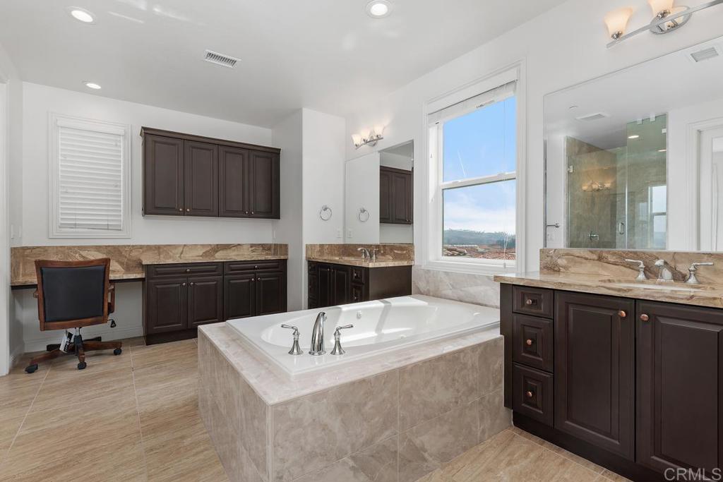 2527 Wellspring Street Carlsbad, CA 92010 - Photo 4 of 28 a kitchen with a sink a stove a refrigerator and chairs