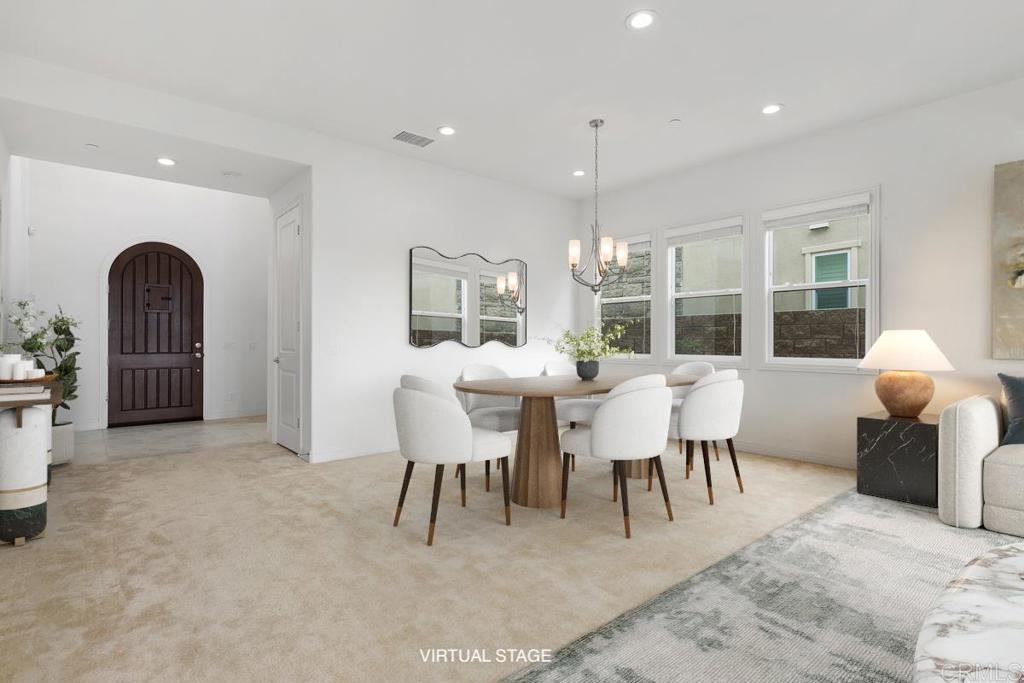 2527 Wellspring Street Carlsbad, CA 92010 - Photo 7 of 28 a view of a dining room with furniture and chandelier