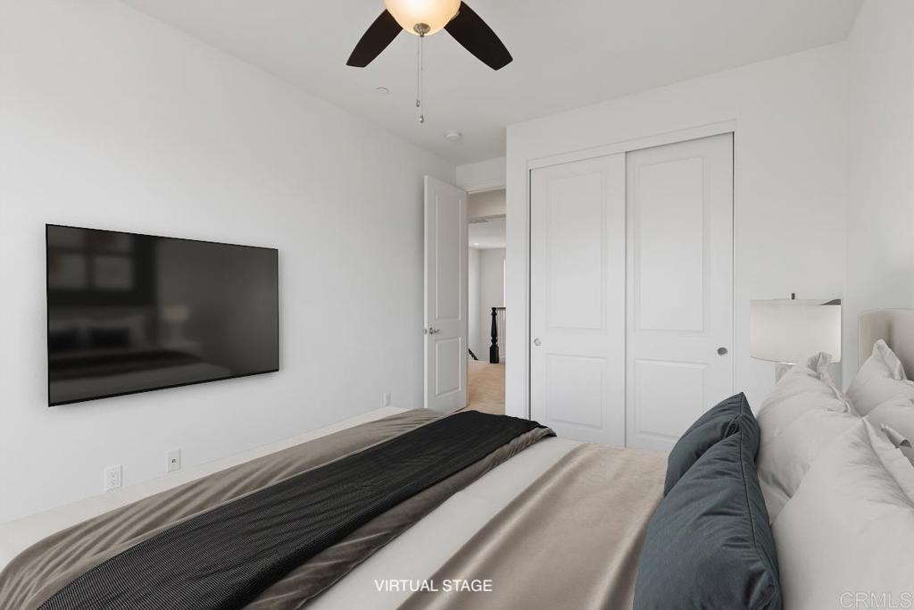 2527 Wellspring Street Carlsbad, CA 92010 - Photo 10 of 28 a bedroom with a bed and a flat screen tv