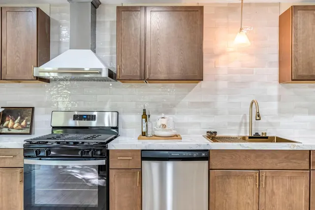 a kitchen with a stove and a white cabinets