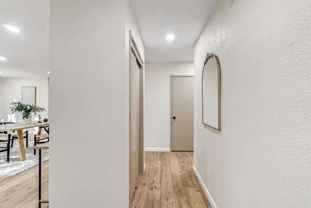 a view of a room with wooden floor and furniture