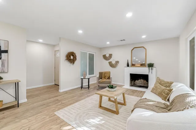 a living room with furniture and a fireplace