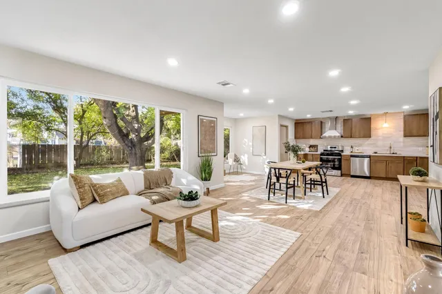 a living room with furniture and a wooden floor