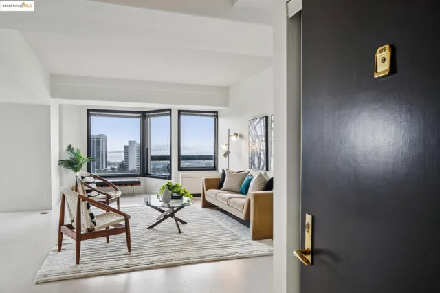 a living room with furniture and a floor to ceiling window