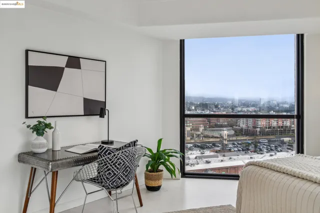 a bedroom with a bed and a large window