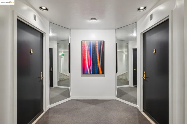 a view of a lobby with a floor to ceiling window and potted plants