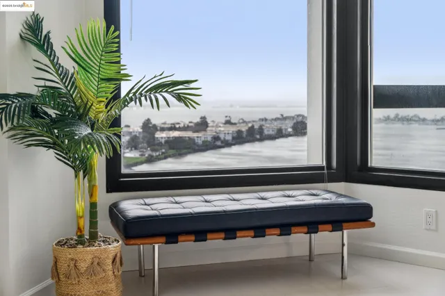 a view of a balcony with furniture and floor to ceiling window
