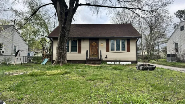 a house that has a tree in front of it