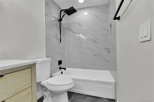 a bathroom with a sink a toilet and a bathtub