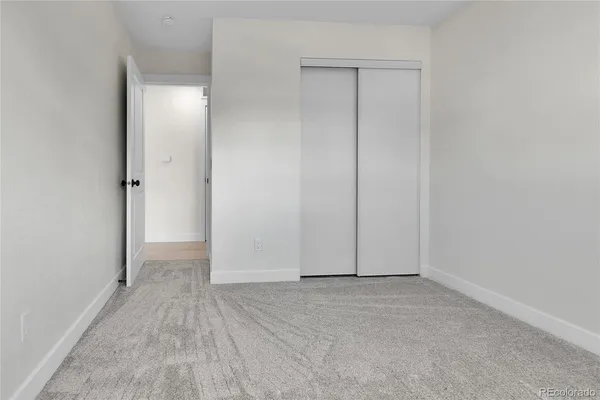 an empty room with closet area
