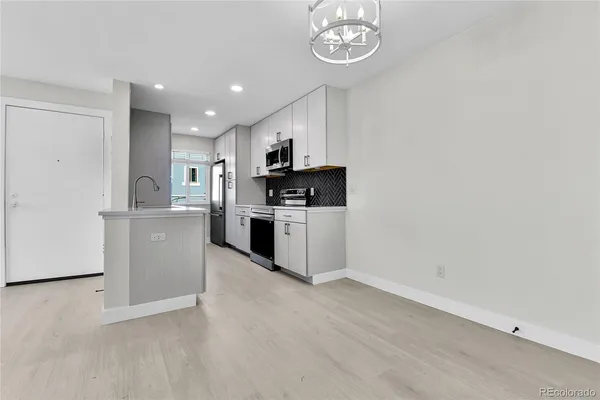 a kitchen with a sink and a refrigerator