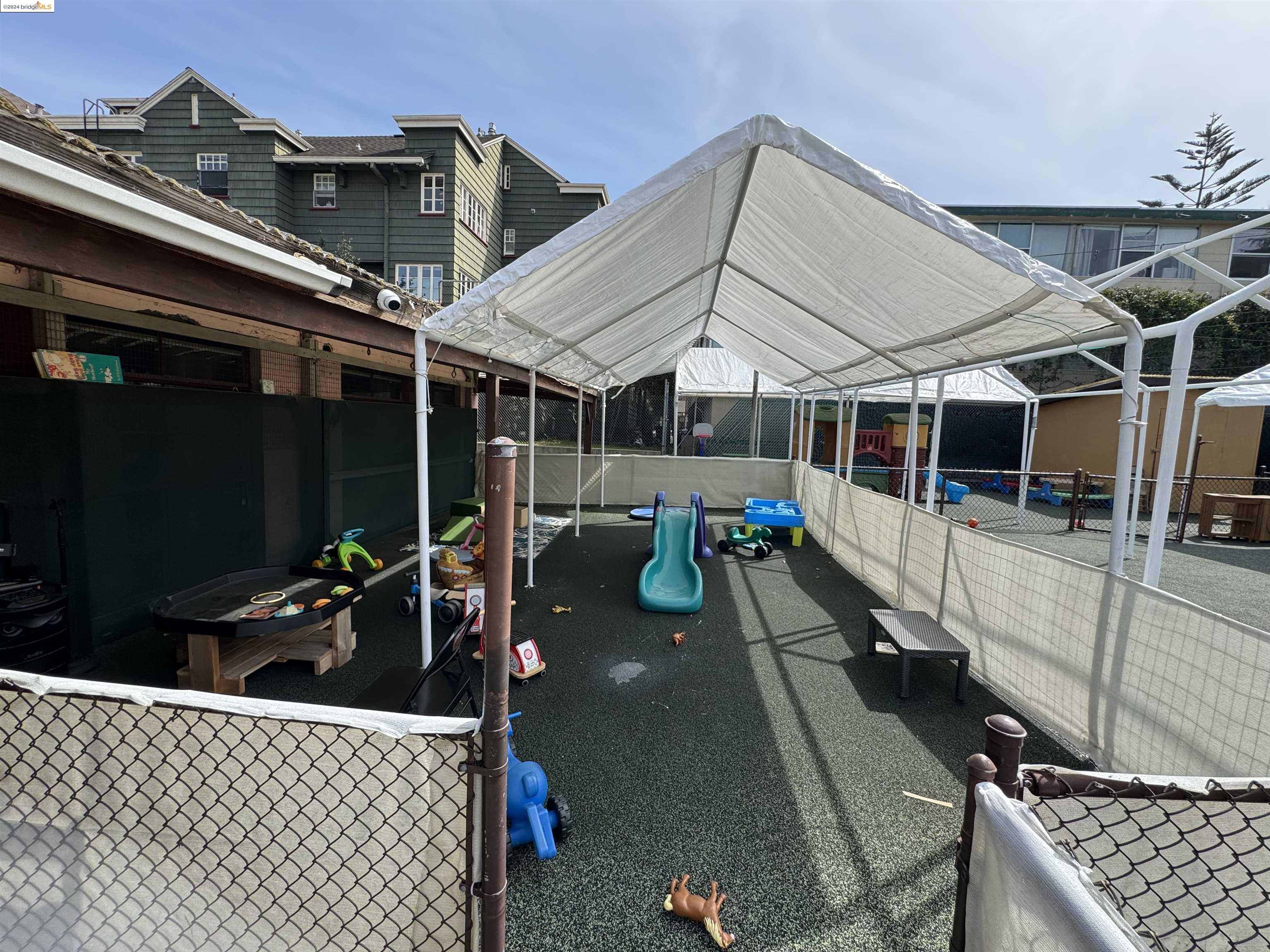 2330 Prince Street Berkeley, CA 94705 - Photo 19 of 55 a view of a patio with table and chairs barbeque potted plants and large tree