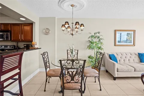 a view of a dining room with furniture and a potted plant
