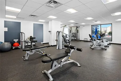 a large kitchen with stainless steel appliances a sink and a stove
