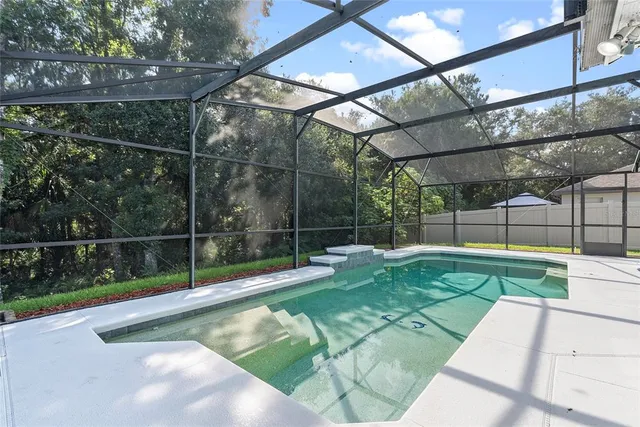 a view of a backyard with a small swimming pool