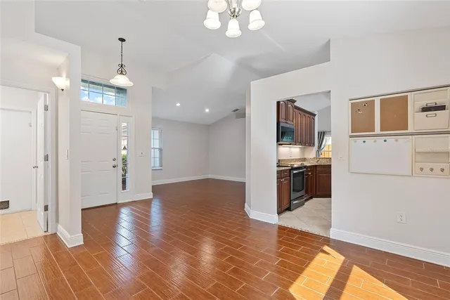 a view of a kitchen with wooden floor and a kitchen