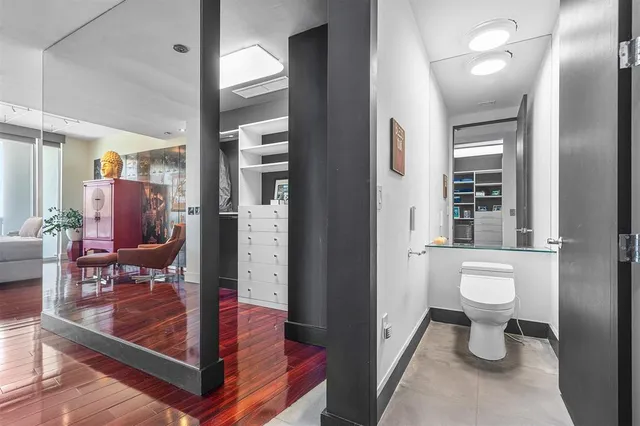 a living room with furniture a flat screen tv and a large window