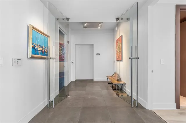 a living room with furniture a window and gym equipment