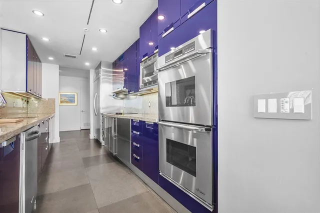 a view of a swimming pool with outdoor seating and plants