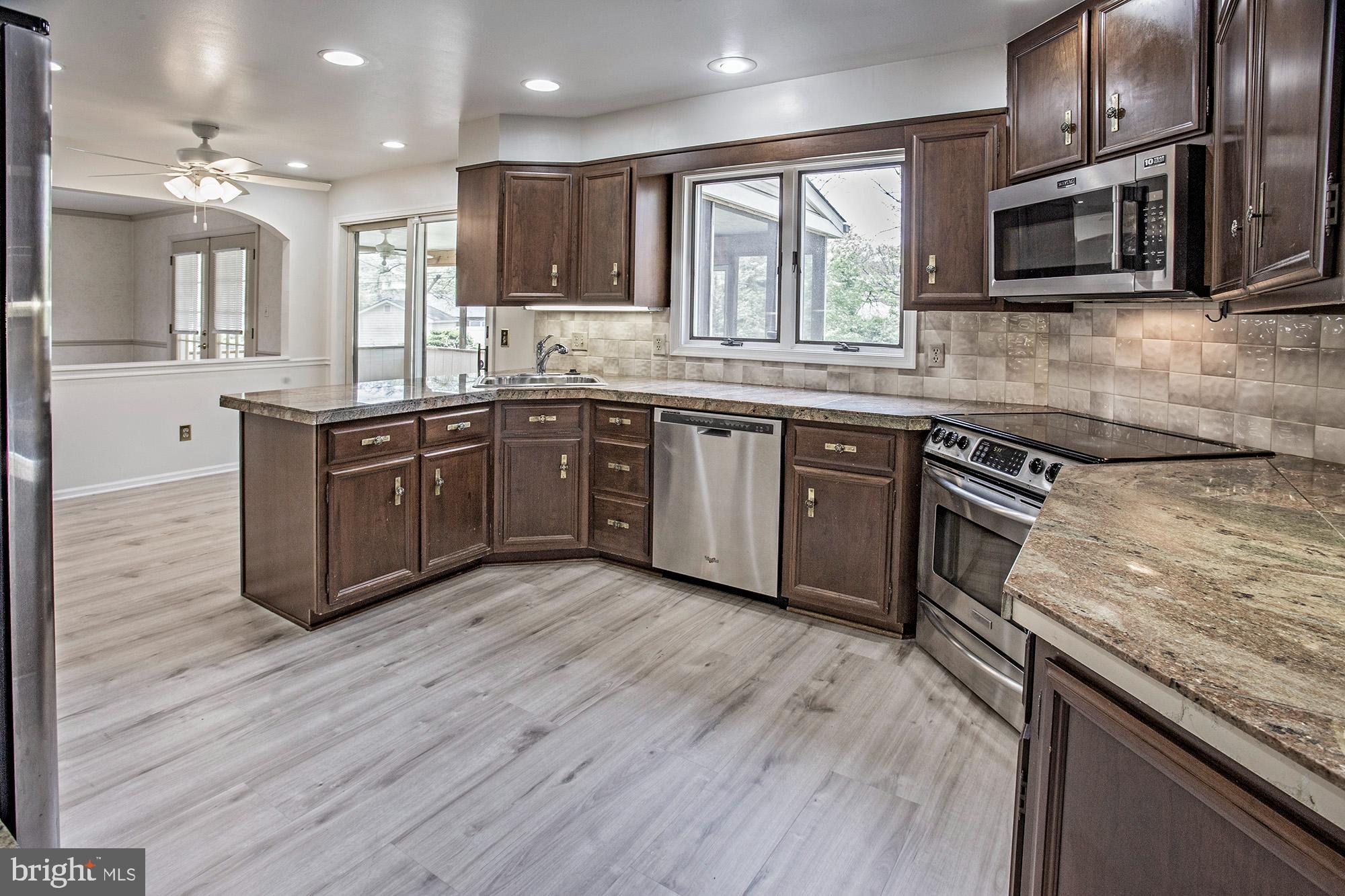 1139 Webster Drive Wilmington, DE 19803 - Photo 12 of 37 a kitchen with stainless steel appliances granite countertop wooden cabinets granite counter tops and a hard wood floors
