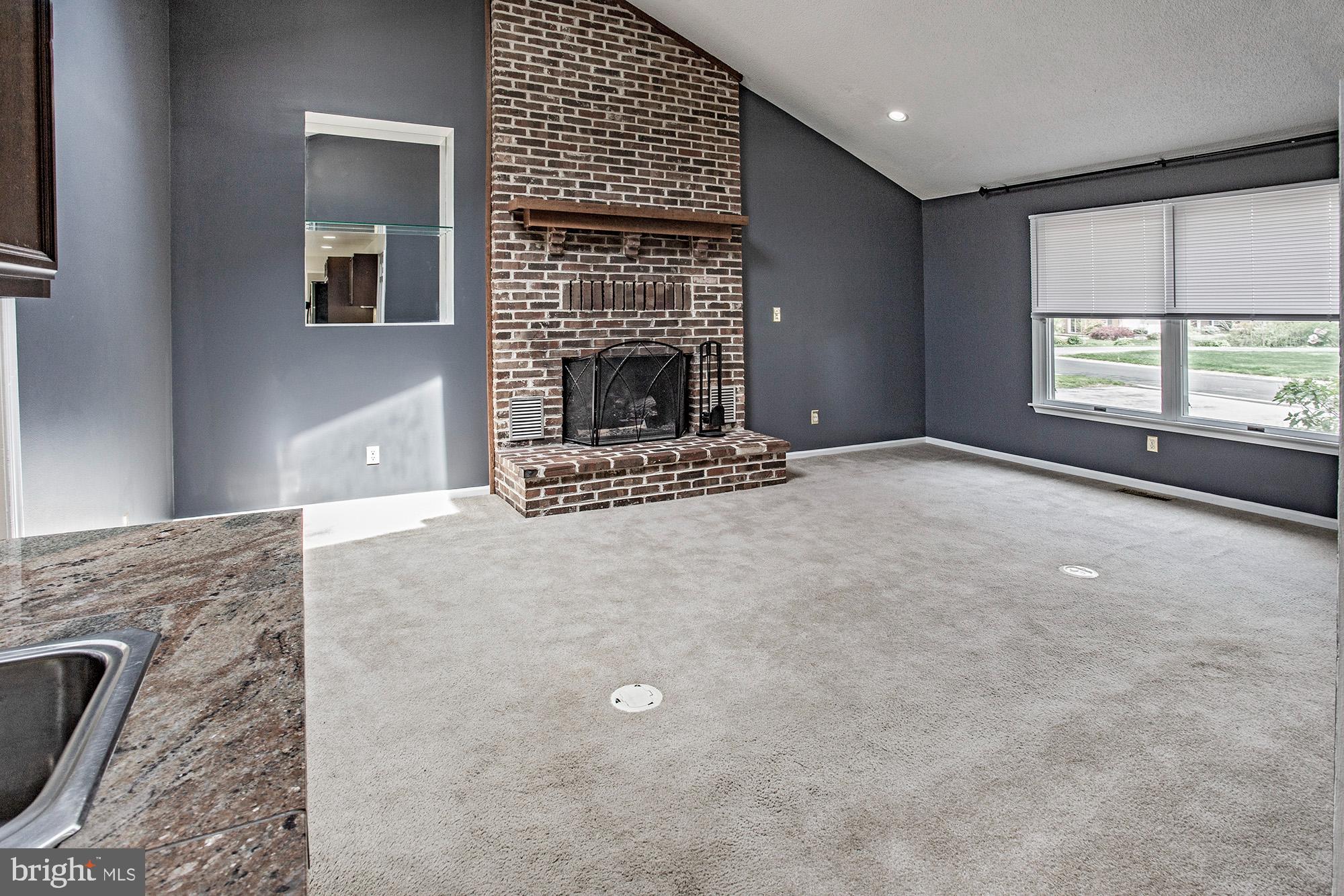 1139 Webster Drive Wilmington, DE 19803 - Photo 17 of 37 a view of an empty room with a fireplace and a window
