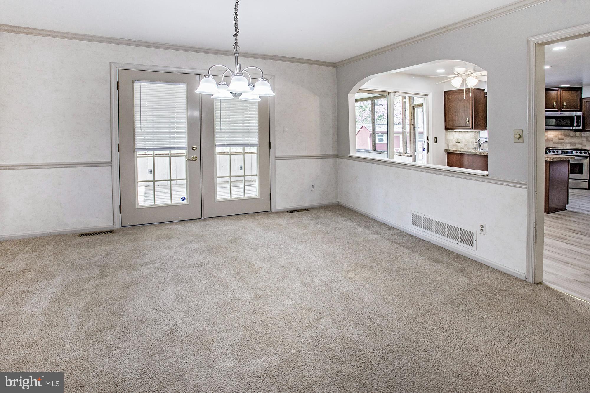 1139 Webster Drive Wilmington, DE 19803 - Photo 21 of 37 an empty room with chandelier and windows