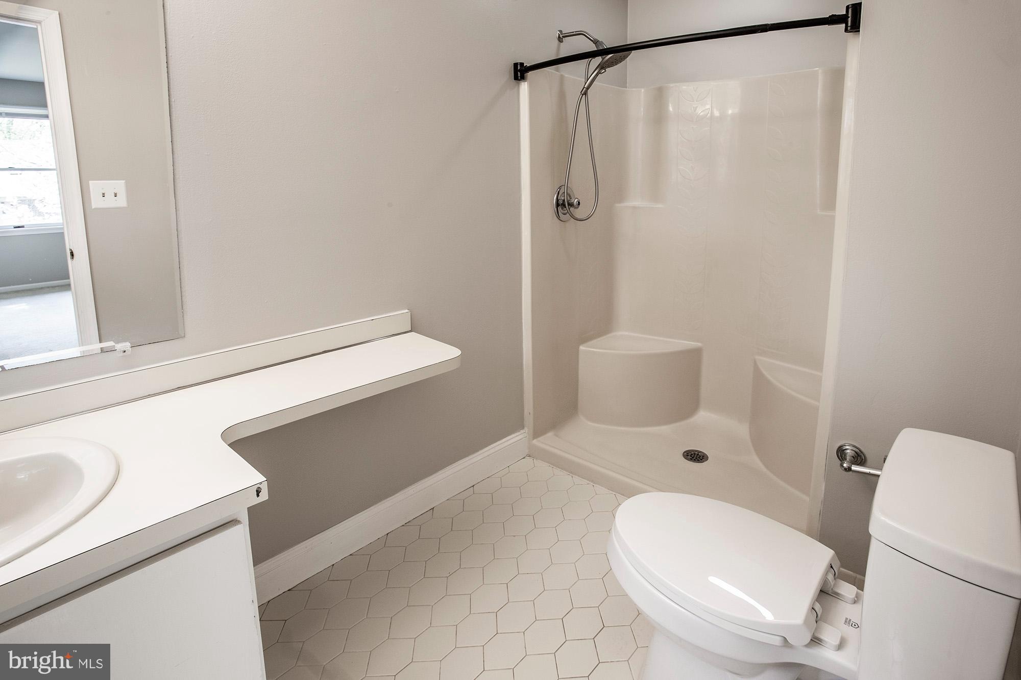 1139 Webster Drive Wilmington, DE 19803 - Photo 25 of 37 a white toilet sitting next to a bathroom sink