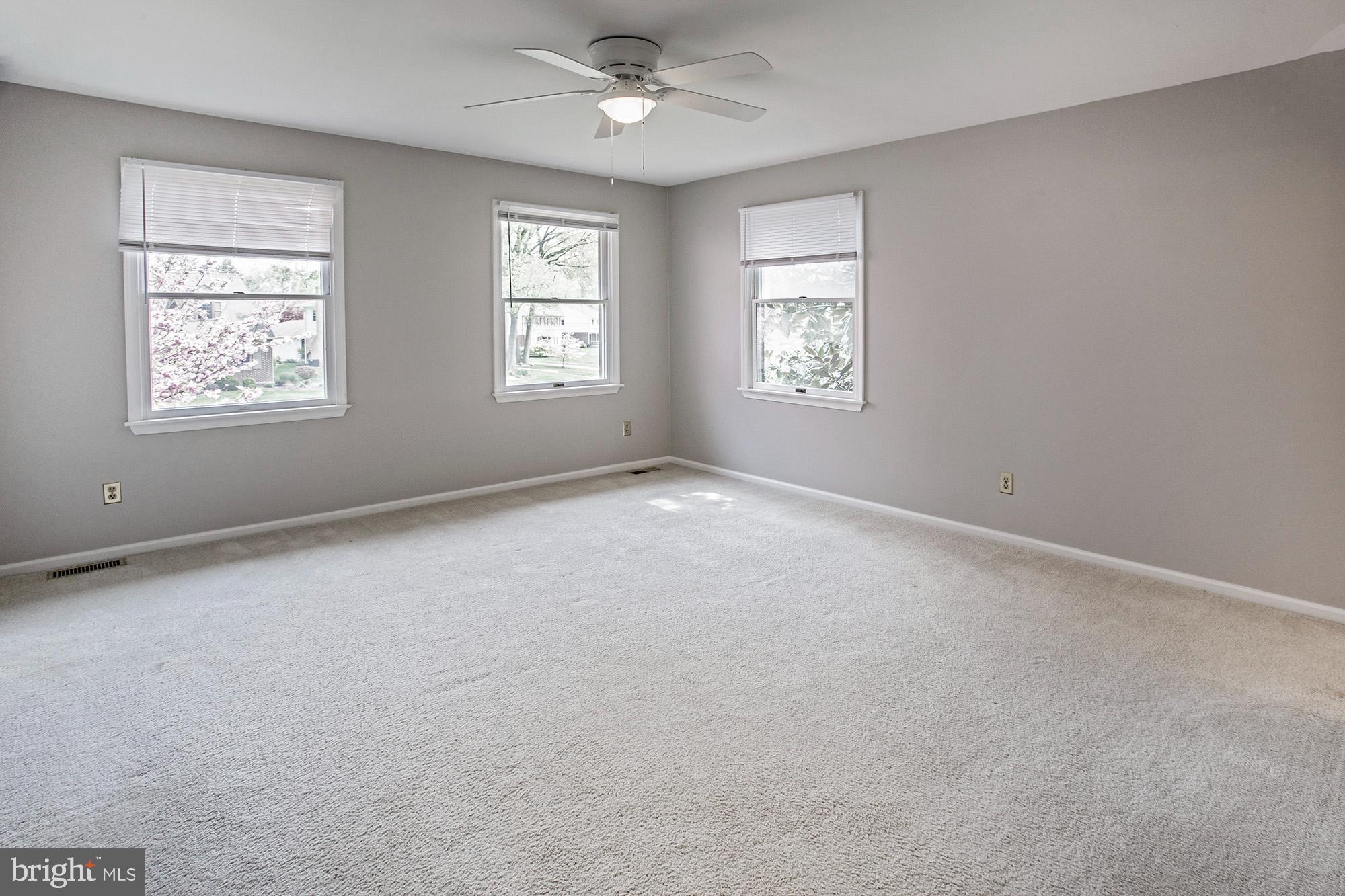 1139 Webster Drive Wilmington, DE 19803 - Photo 27 of 37 an empty room with windows and ceiling fan