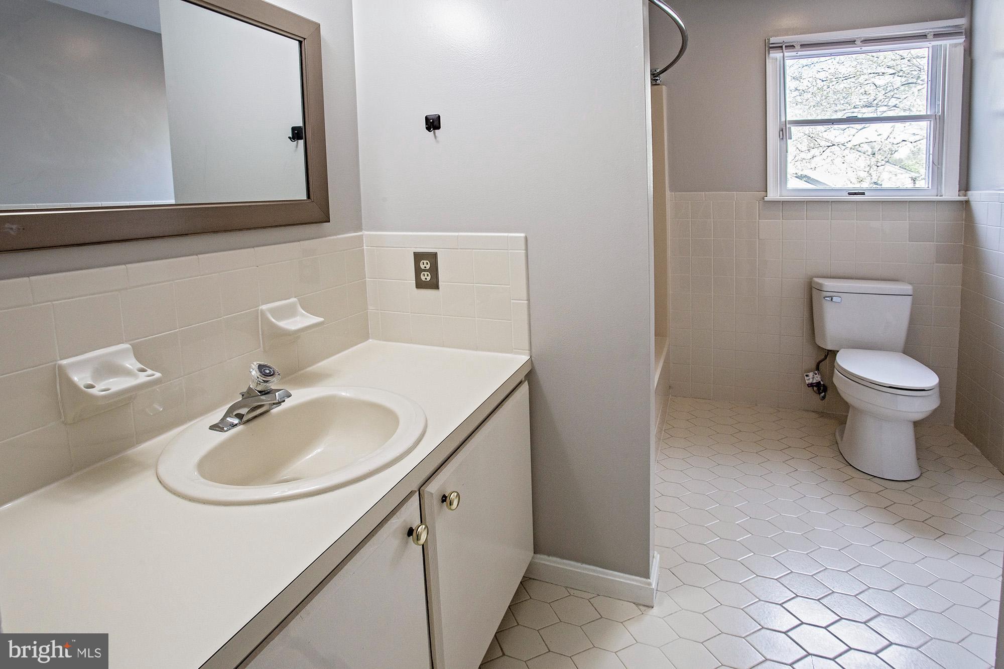 1139 Webster Drive Wilmington, DE 19803 - Photo 29 of 37 a bathroom with a sink a toilet and mirror