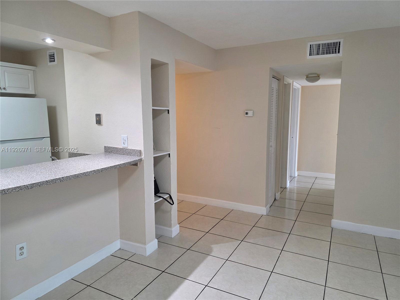 4400 West 16th Avenue, Unit 630 Hialeah, FL 33012 - Photo 12 of 34 a view of kitchen with white cabinets