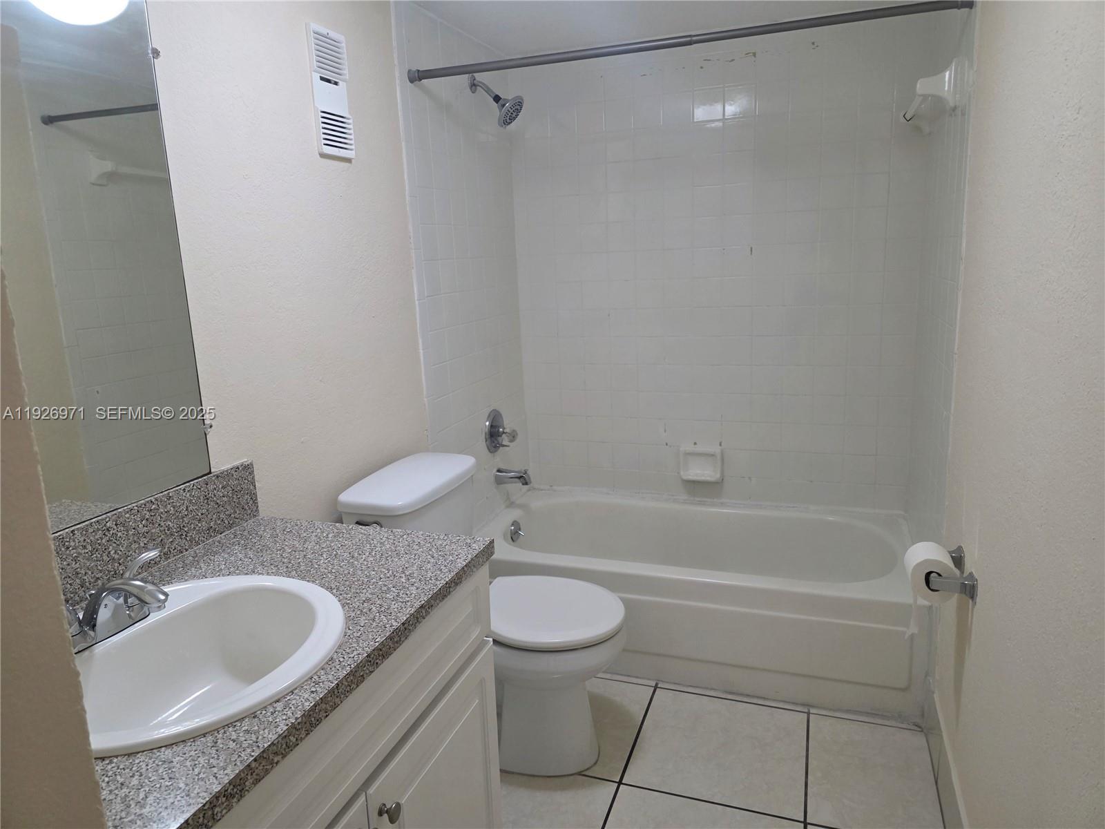 4400 West 16th Avenue, Unit 630 Hialeah, FL 33012 - Photo 14 of 34 a bathroom with a granite countertop sink toilet and shower