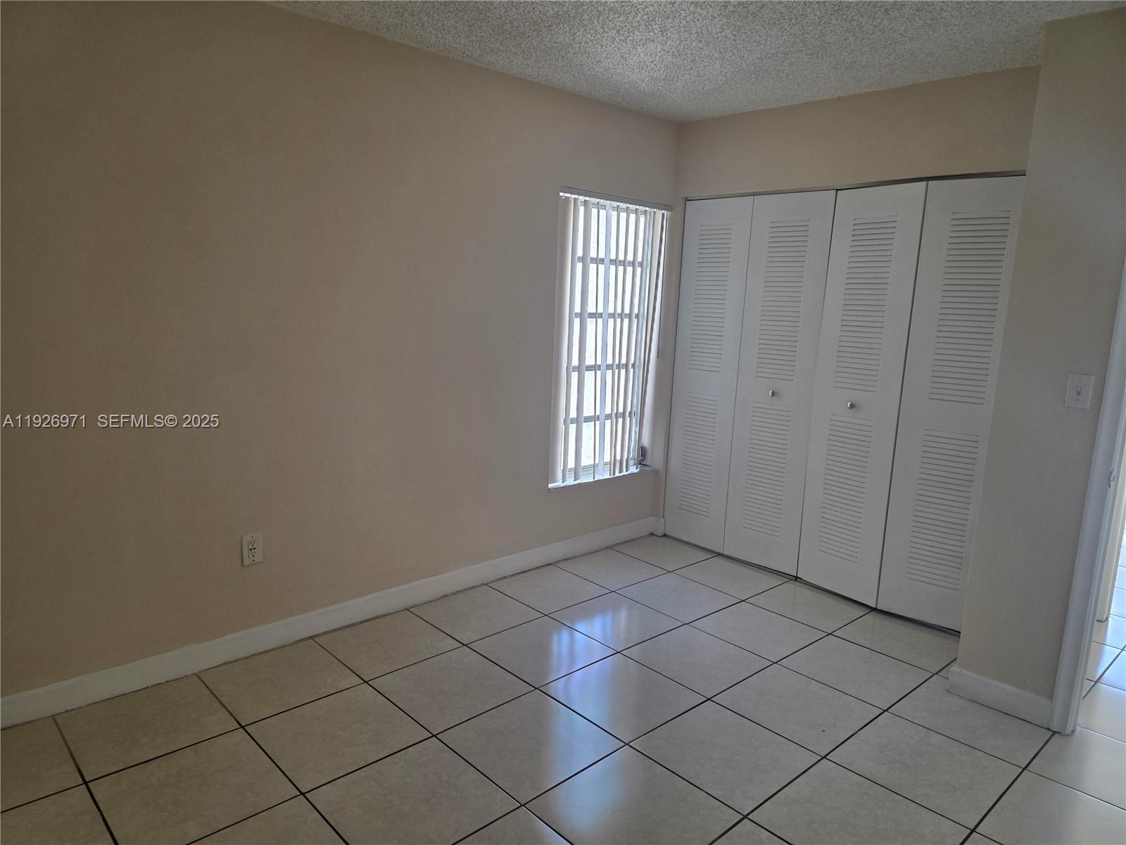 4400 West 16th Avenue, Unit 630 Hialeah, FL 33012 - Photo 17 of 34 a view of an empty room and window
