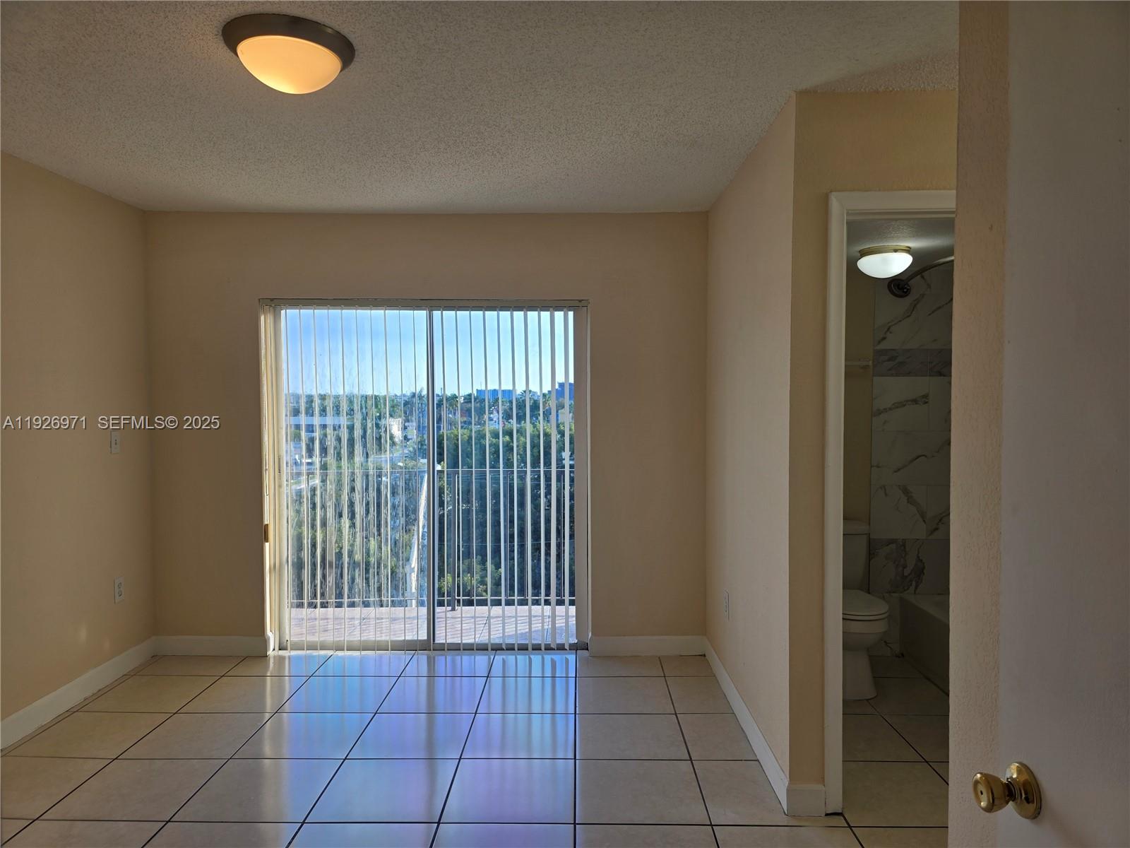 4400 West 16th Avenue, Unit 630 Hialeah, FL 33012 - Photo 21 of 34 a view of an empty room with a window