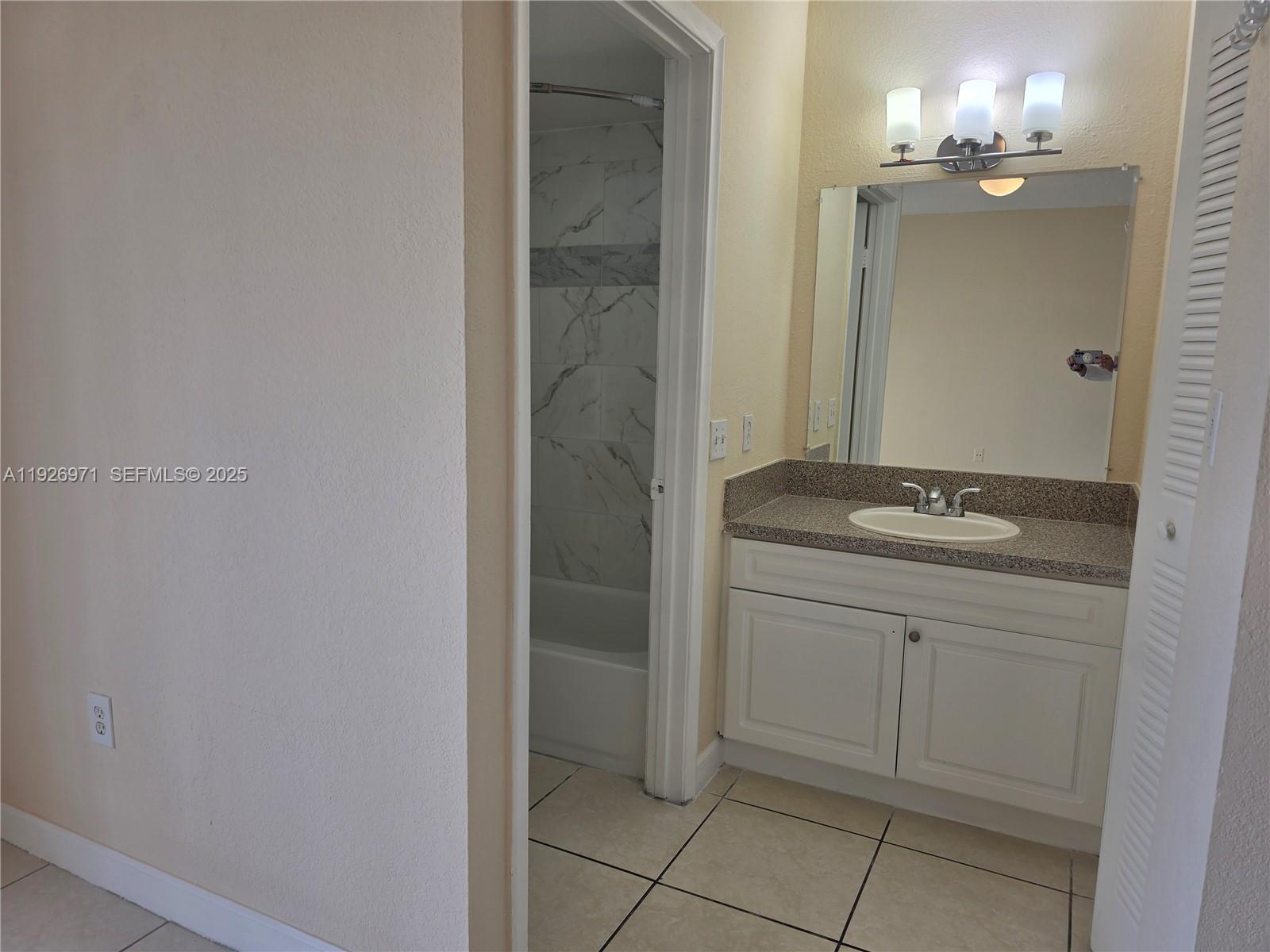 4400 West 16th Avenue, Unit 630 Hialeah, FL 33012 - Photo 23 of 34 a bathroom with a sink and a mirror