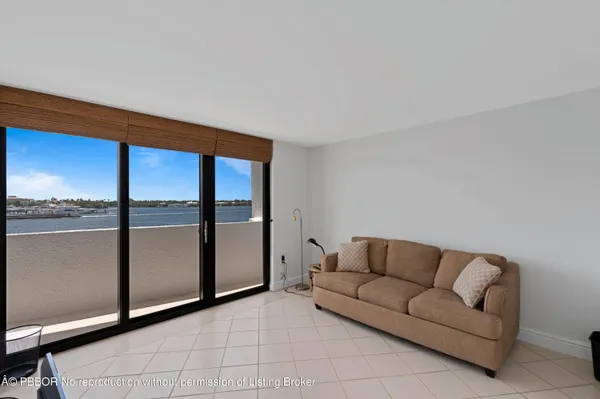 a living room with furniture and a floor to ceiling window