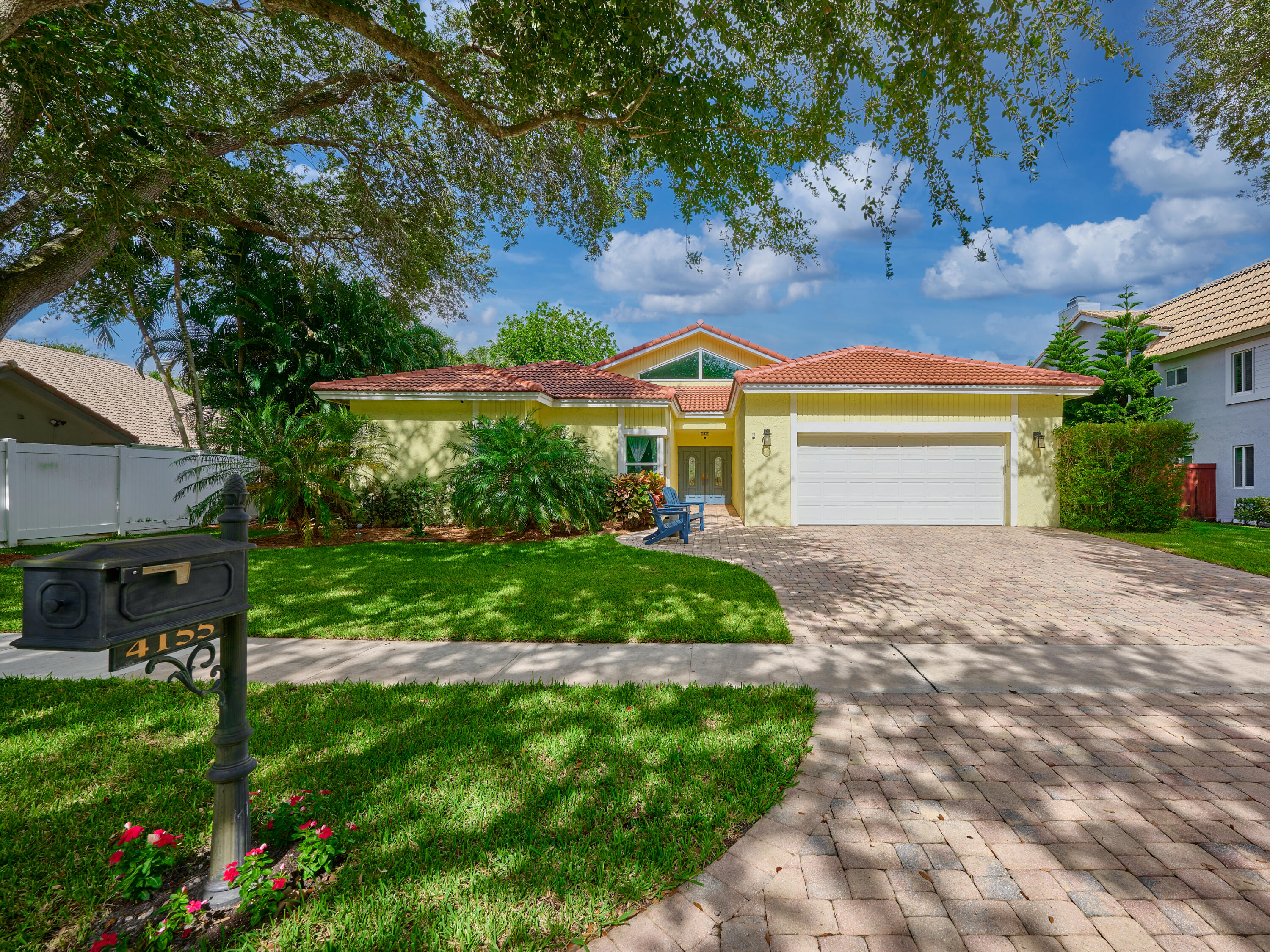 4155 Northwest 25th Way Boca Raton, FL 33434 - Photo 3 of 66 a front view of a house with a garden and plants
