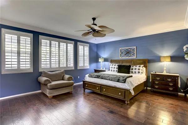 a spacious bedroom with a bed and a couch