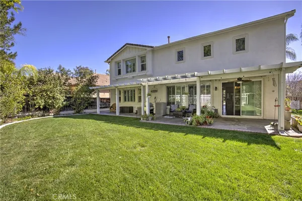 a view of a house with a yard patio and swimming pool