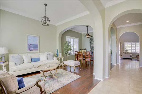 a living room with furniture and a chandelier