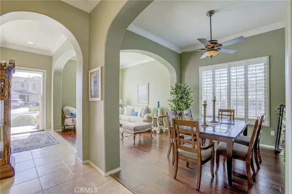 a dining room with furniture window and wooden floor