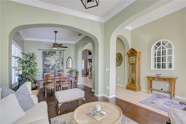 a living room with furniture and a chandelier