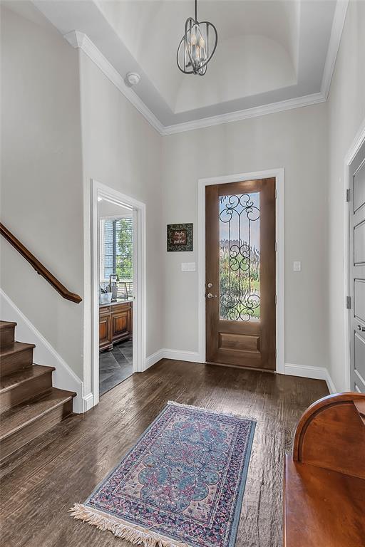 1014 Rennard Street Caddo Mills, TX 75135 - Photo 6 of 39 Entryway featuring wood-finish flooring, a decorative glass front door, and a coffered ceiling with a contemporary light fixture