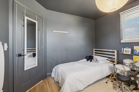 a bedroom with a bed and a chandelier