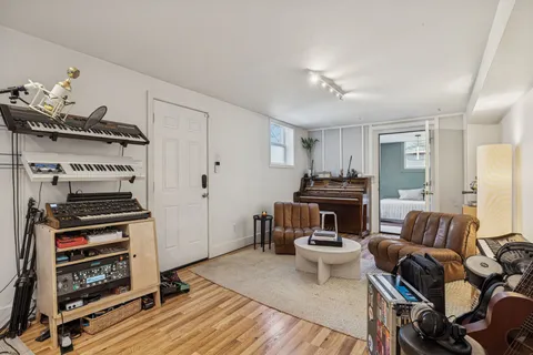a living room with furniture and a piano