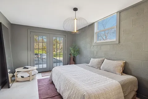 a bedroom with a bed and a window