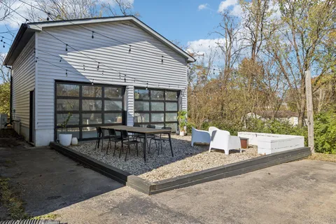 a view of a patio with a table and chairs and couches