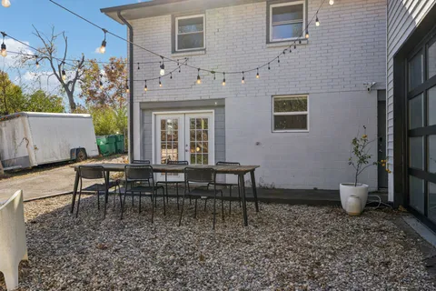 a view of a patio with a table and chairs