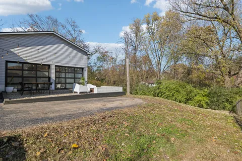 a couple of table and chairs in front of house